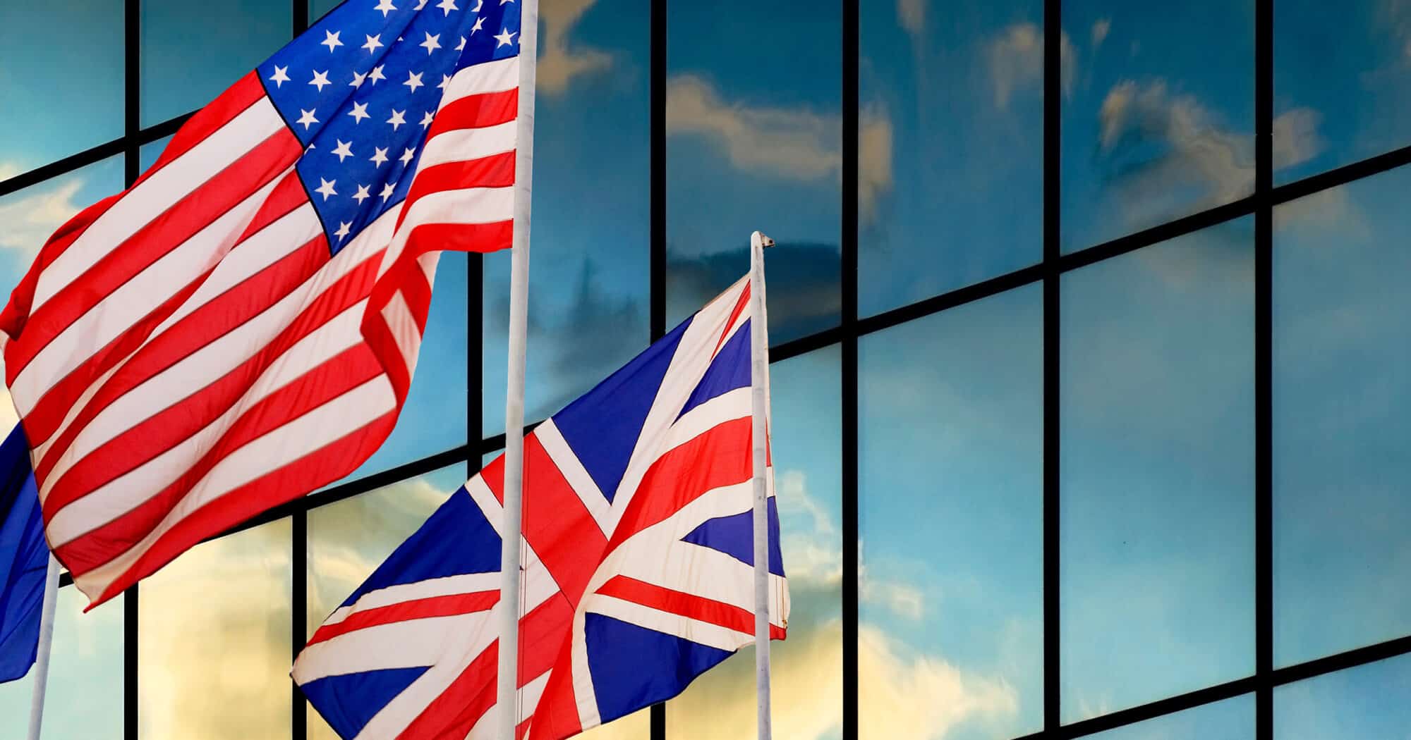 The United States and United Kingdom flags in the wind.