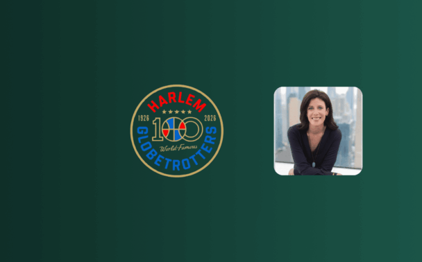 A Harlem Globetrotters 100th anniversary logo is on the left, and a woman with dark hair, wearing a dark top, is smiling and sitting at a desk on the right, set against a green background.