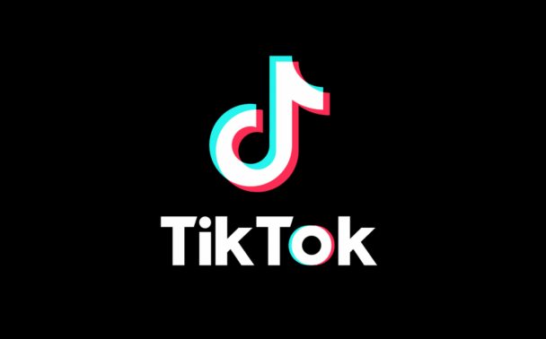 TikTok logo with a stylized musical note above the word TikTok in bold white letters, all set against a solid black background. The logo has blue and pink shadow accents.