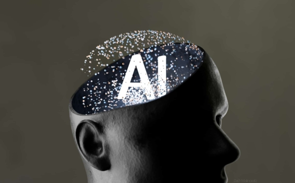 A dark, stylized human head with the top of the skull removed, revealing the letters AI inside, surrounded by glowing particles, symbolizing artificial intelligence in the mind.