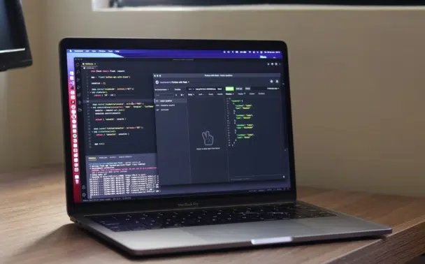 A laptop displaying Python Flask code and an API testing interface on its screen.